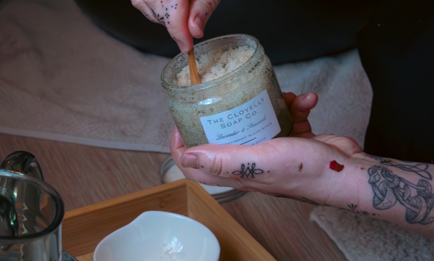 Scooping foot scrub from a jar for a Root Ritual